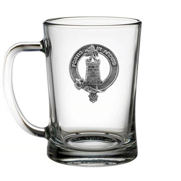 A clear glass mug with an embossed emblem on it.