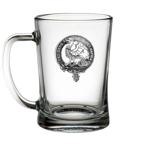 A clear glass mug with an embossed emblem on it.