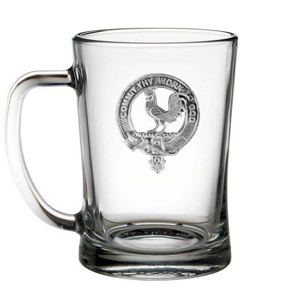 A clear glass mug with an embossed logo featuring a rooster and the text "I commit to thy work god".