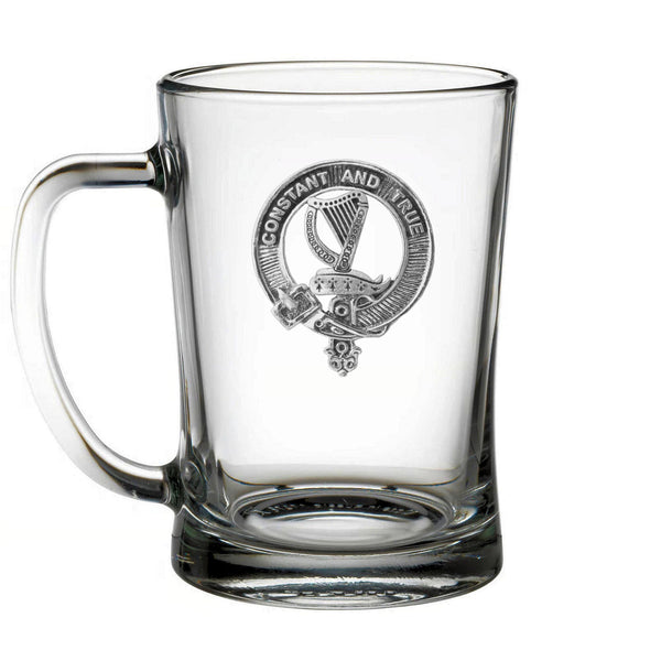A clear glass mug with an embossed logo on it.