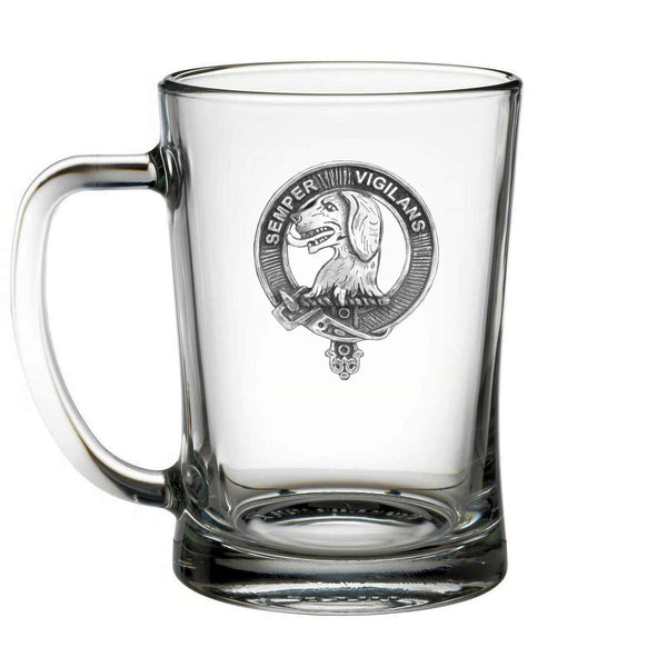 A clear glass mug with a silver emblem featuring a dog and the text "VIGILANT" printed on it.
