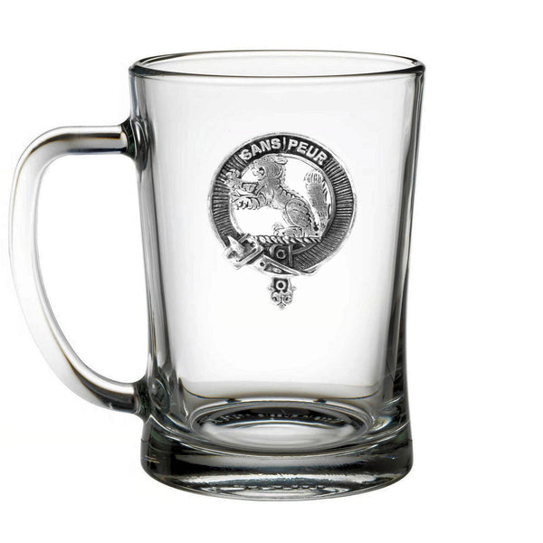 A clear glass mug with a black and white engraved design on it.