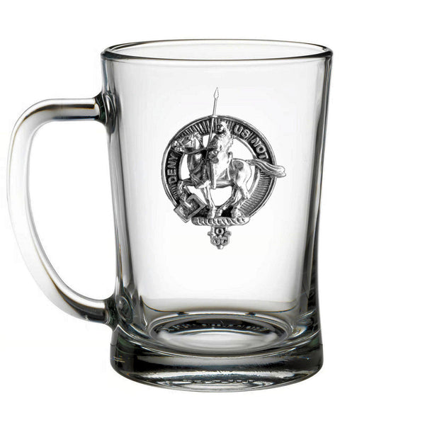 A clear glass mug with a silver emblem featuring a person riding a horse.